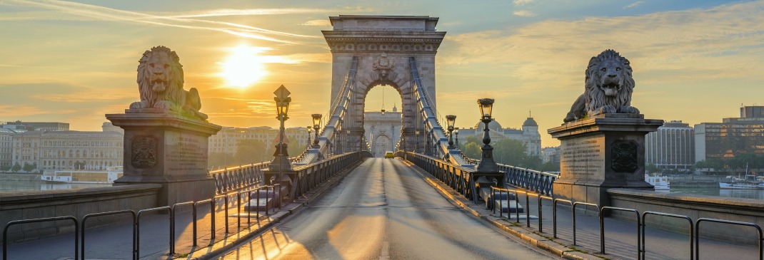 Budapest’s Chain Bridge as the sun sets in the background